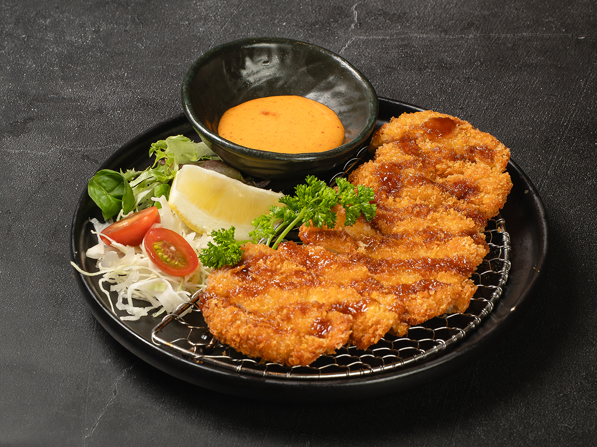 Chicken katsu with cabbage, lemon, and dipping sauce