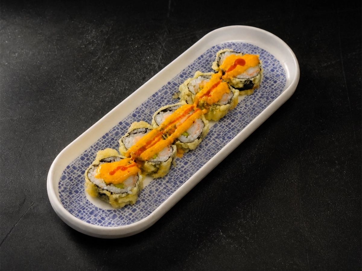 Dynamite sushi roll topped with spicy sauce