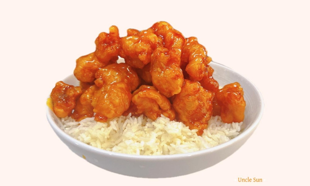 Crispy orange chicken served over steamed rice at Uncle Sun, a Chinese Restaurant in Eugene