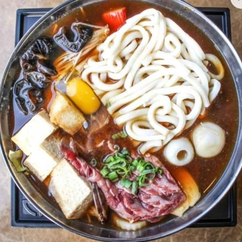Savory beef udon hot pot with tofu and mushrooms at Uniboil Phresh Teas Co, a Hot Pot Restaurant in Goleta.