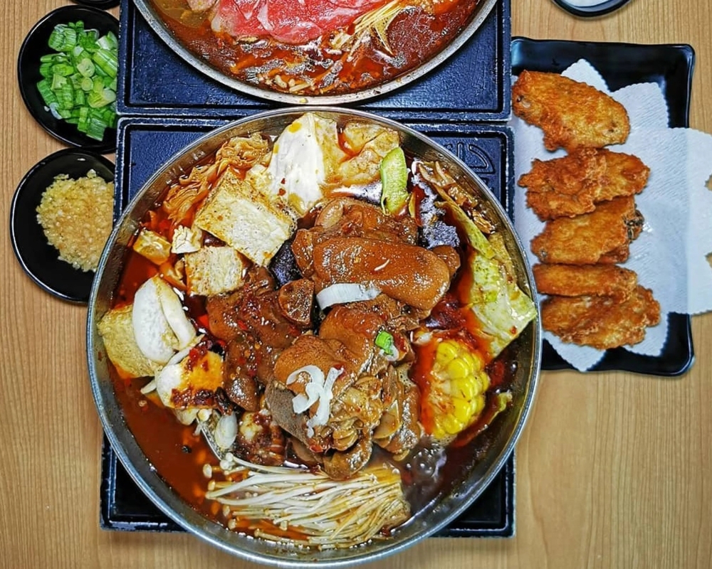 Signature spicy hot pot with fried chicken wings at Uniboil Phresh Teas Co, a Hot Pot Restaurant in Goleta.
