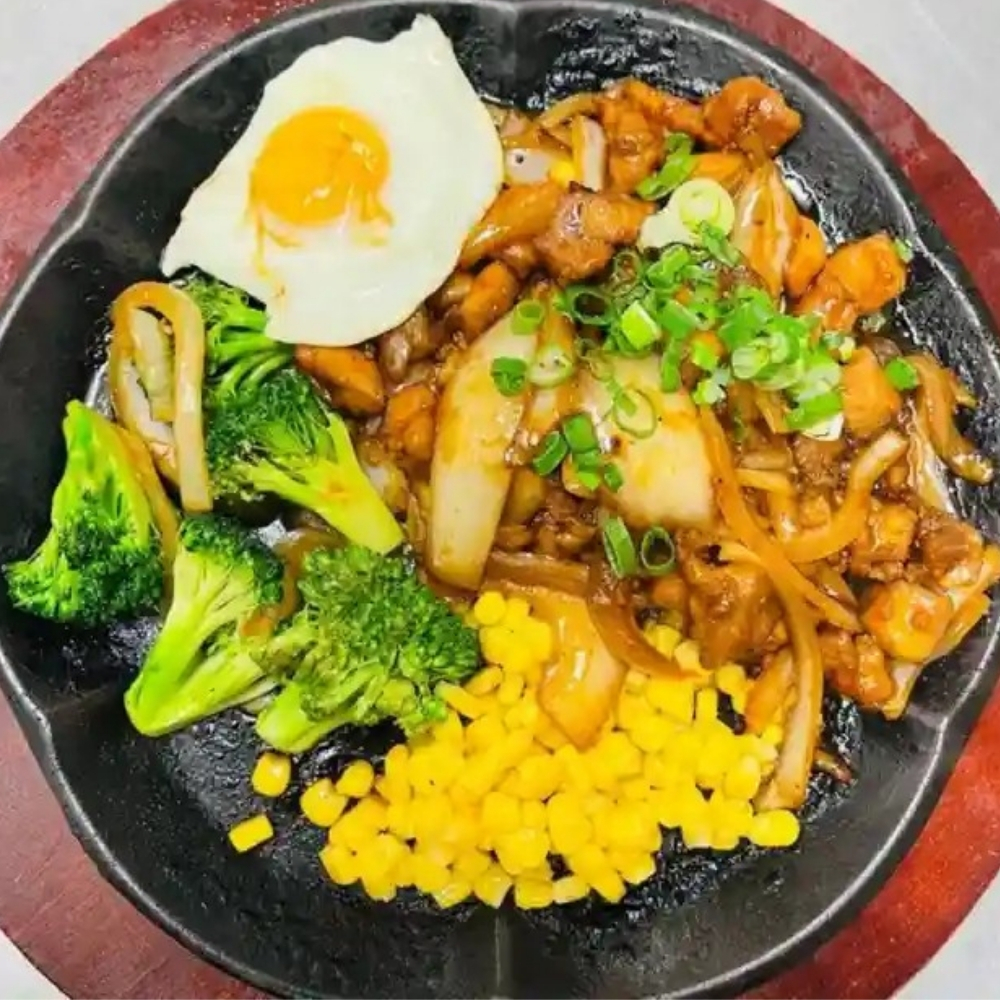 Sizzling chicken with egg, broccoli, and corn at Uniboil Phresh Teas Co, a Hot Pot Restaurant in Goleta.