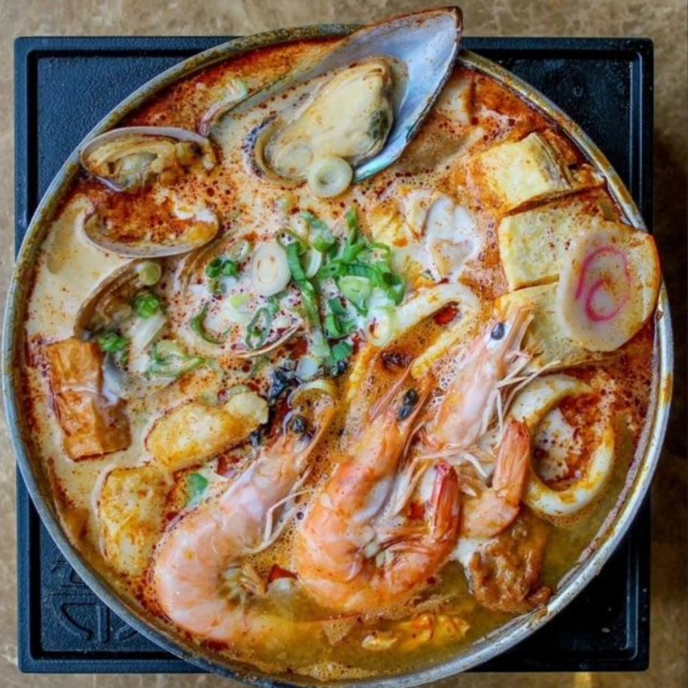 Spicy tom yum seafood hot pot with shrimp and mussels at Uniboil Phresh Teas Co, a Hot Pot Restaurant in Goleta.
