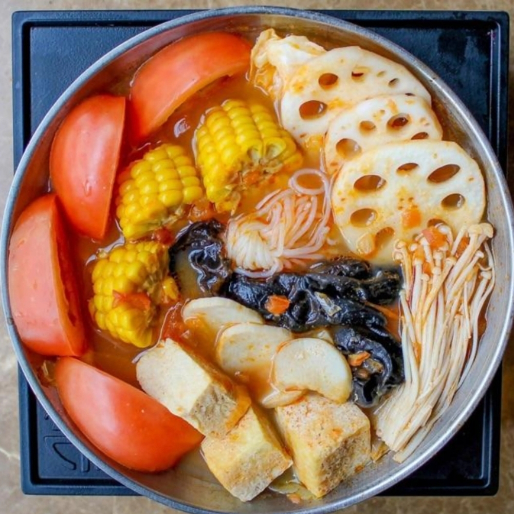 Fresh tomato vegetable hot pot with corn and lotus root at Uniboil Phresh Teas Co, a Hot Pot Restaurant in Goleta.