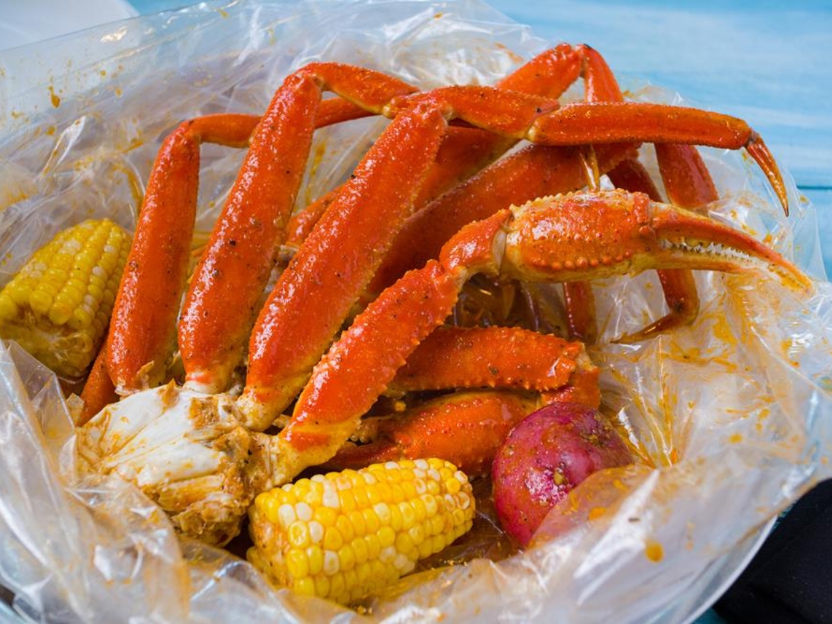 Spicy snow crab legs with corn and potato at Utica Crab & Boil, a Seafood Restaurant in Utica