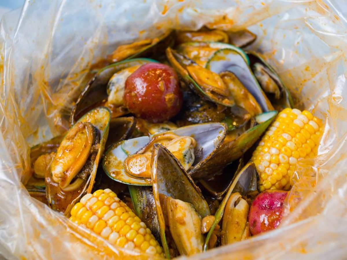 Seasoned mussels with corn and potato in sauce at Utica Crab & Boil, a Seafood Restaurant in Utica