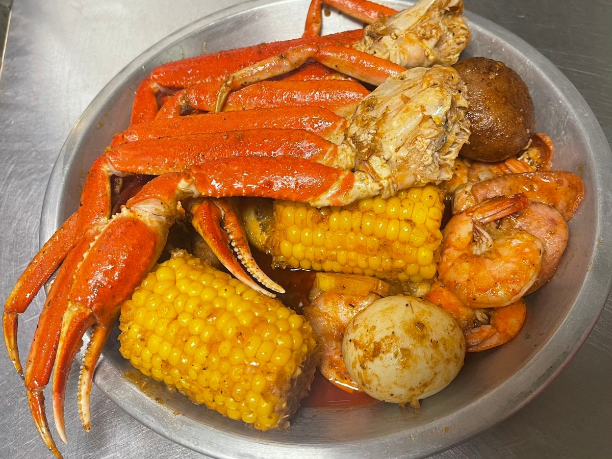 Seafood boil platter with crab legs, shrimp and corn at Utica Crab & Boil, a Seafood Restaurant in Utica