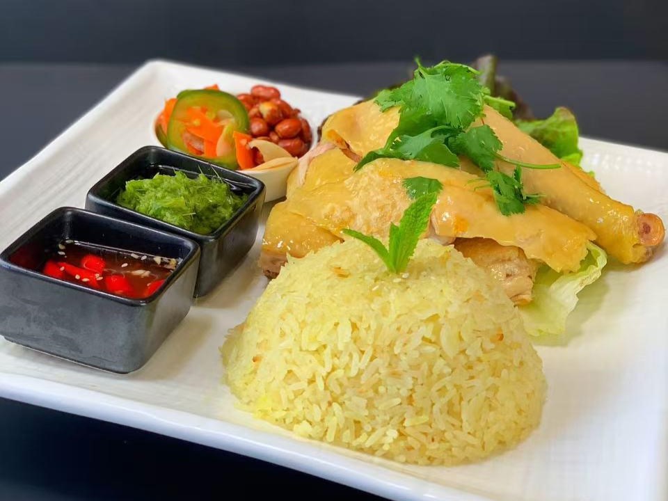 Hainanese chicken rice with dipping sauces and herbs at Viet Quan Vietnamese Noodle House, a Vietnamese Restaurant in San Francisco