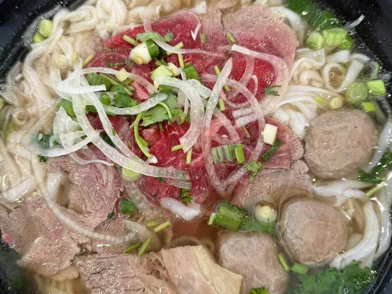 Beef pho with rare steak, meatballs and herbs at Viet Quan Vietnamese Noodle House, a Vietnamese Restaurant in San Francisco