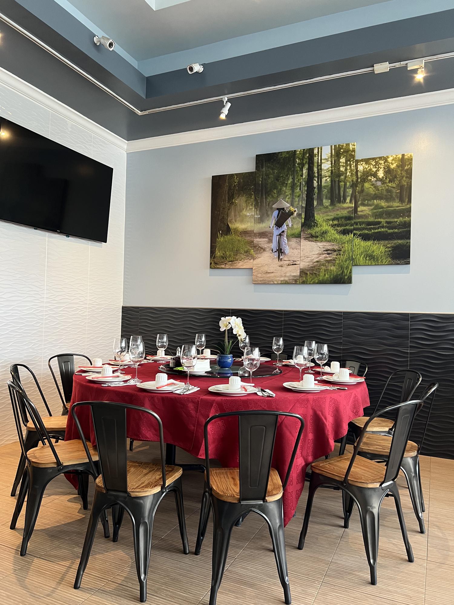 Dining room interior with red tablecloth and Vietnamese art at Viet Quan Vietnamese Noodle House, a Vietnamese Restaurant in San Francisco