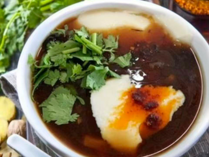 Spicy soup served with crispy fried dough balls at Village Bao 又一村包子，a Chinese Restaurant in Sugar Land