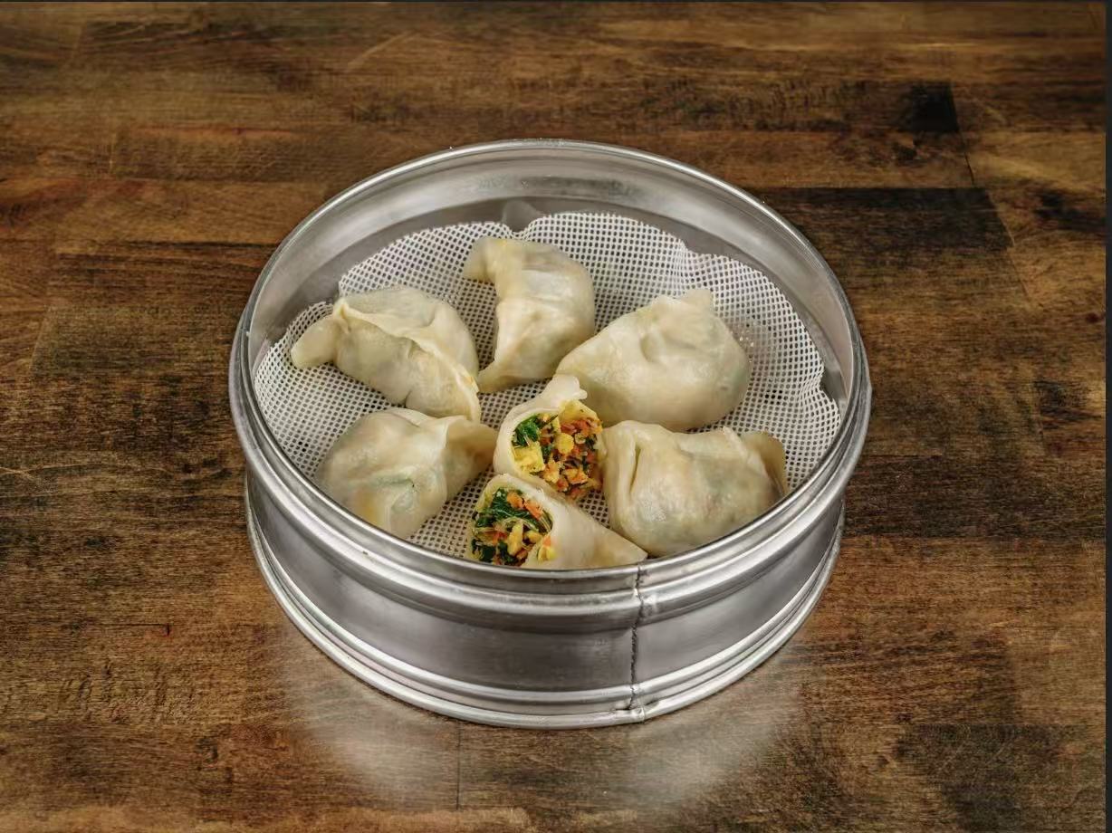 Steamed dumplings filled with fresh vegetable mix at Village Bao 又一村包子，a Chinese Restaurant in Sugar Land