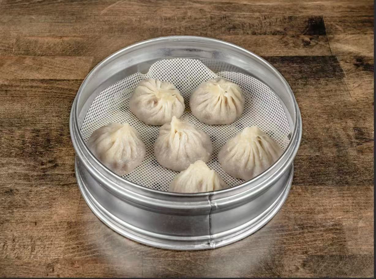 Steamed soup dumplings with juicy pork filling at Village Bao 又一村包子，a Chinese Restaurant in Sugar Land