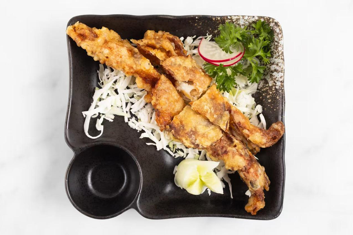 Fried soft shell crab with cabbage and garnish at Wabi Wok & Ramen, an Asian Restaurant in Milford