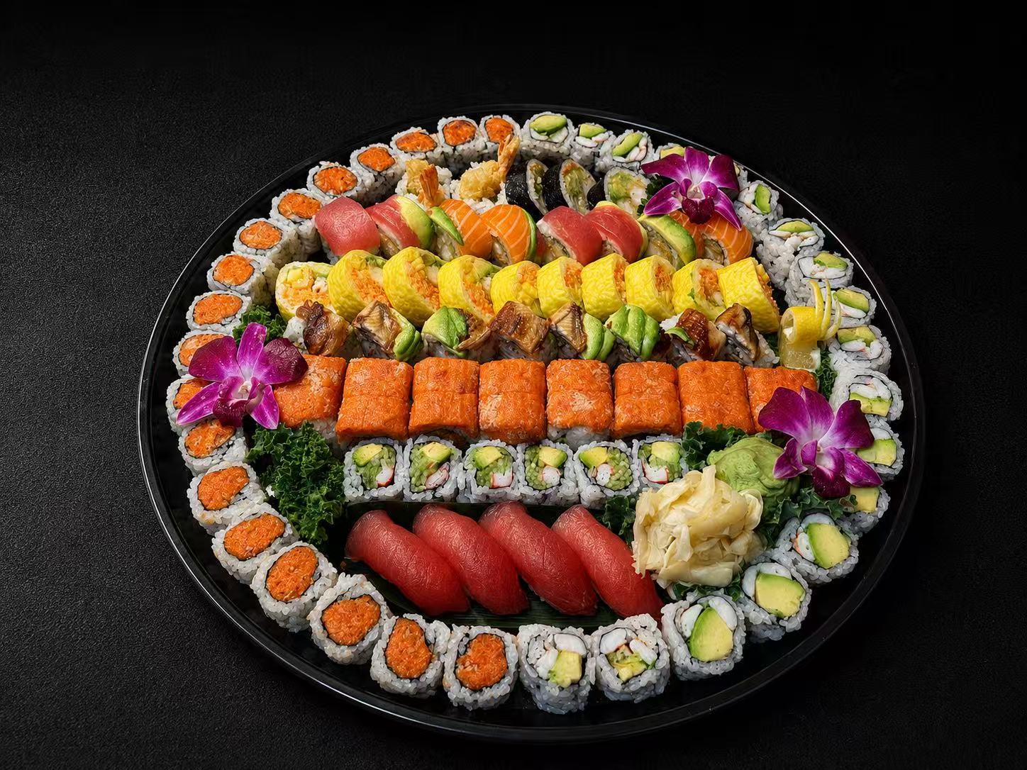 Large sushi platter with assorted rolls, nigiri, and decorative orchids at Wasu Sushi Ramen, a Sushi restaurant in Bedminster