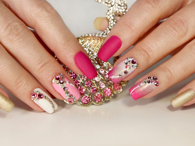 Vibrant pink nail art with gems at Bonnie Nail Salon, a Nail Salon in Brentwood