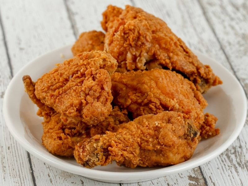Crispy fried chicken pieces on a white ceramic plate at Which Wings, Fast Food Restaurant in Fort Worth