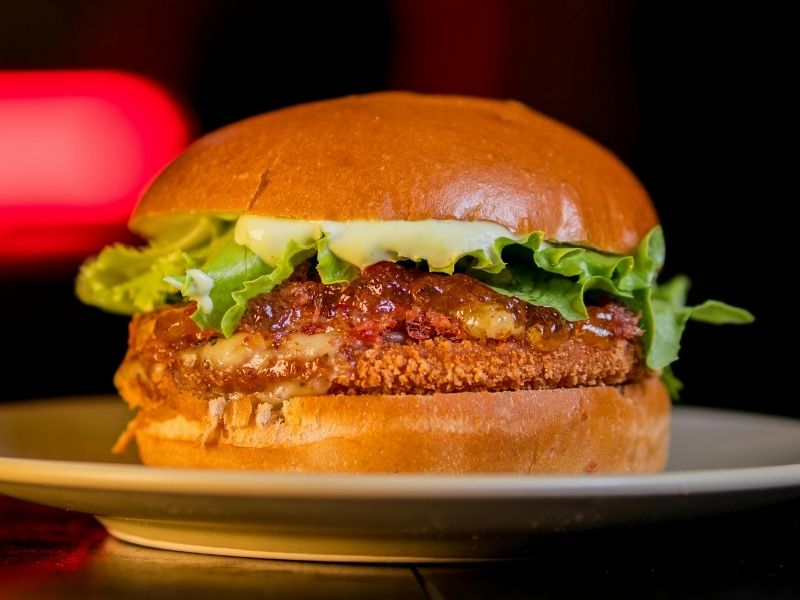 Crispy patty burger with glaze and lettuce on bread at Which Wings, Fast Food Restaurant in Fort Worth