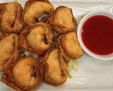 Fried wontons with red dipping sauce at Wild Ginger Asian Bistro, a Asian restaurant in Gilbert
