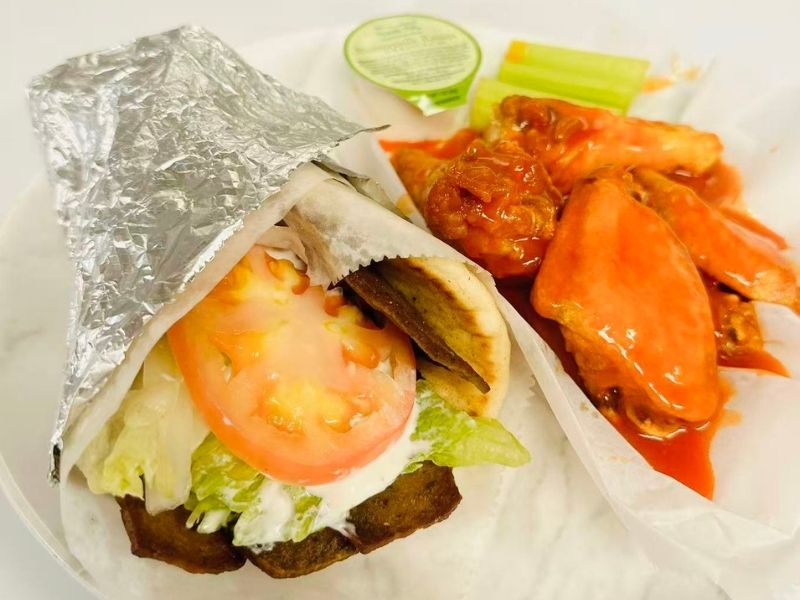 Wing-Side-Cleveland-Fast-Food-Restaurant-Wrap-and-Buffalo-Wings-Cleveland Veggie wrap & buffalo wings with celery at Wing Side - Cleveland, a Fast Food Restaurant in Cleveland