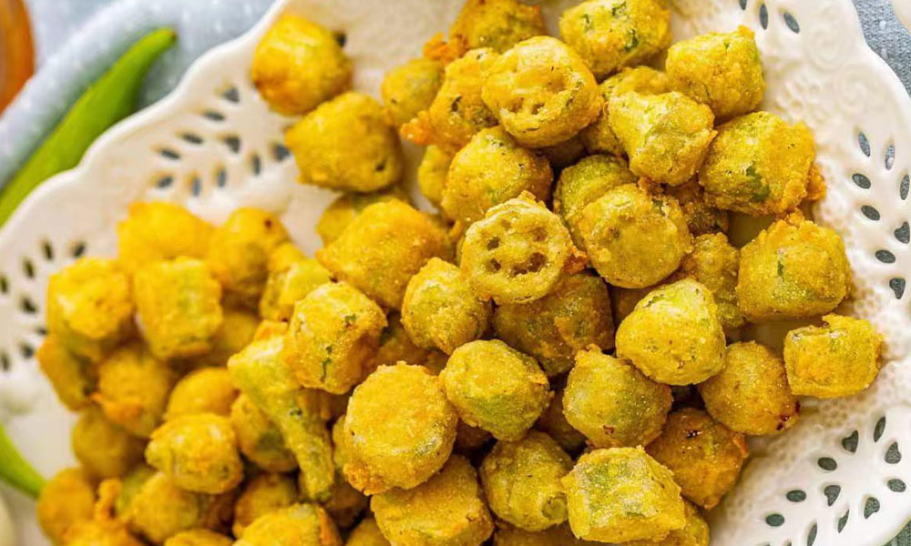 Crispy fried okra bites in decorative white serving plate