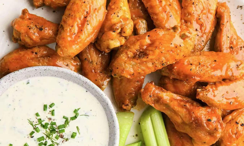 Buffalo chicken wings with blue cheese dip and celery sticks