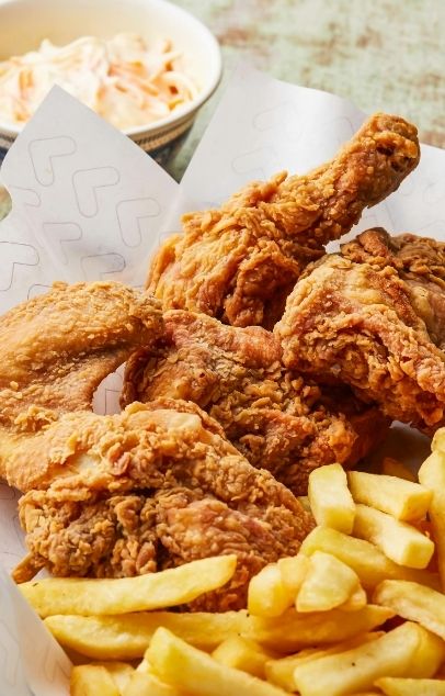Fried chicken meal with fries and creamy coleslaw on the side at Wing Star, a American fusion restaurant in Amsterdam