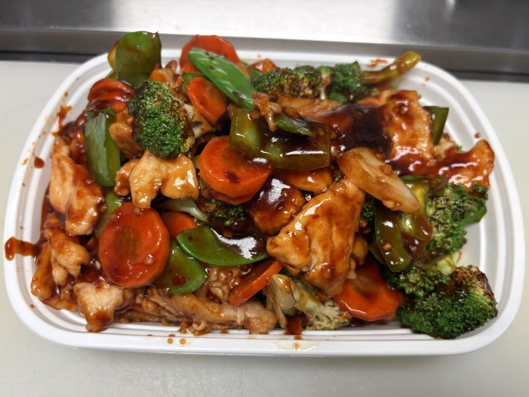 Stir - fried chicken with veggies in Hunan - style sauce.