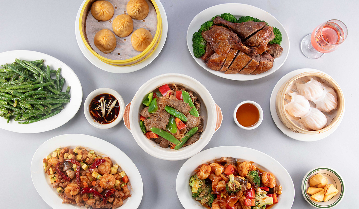 Chinese spread featuring roast duck and steamed dumplings at Wok 88, a Chinese Restaurant in New York