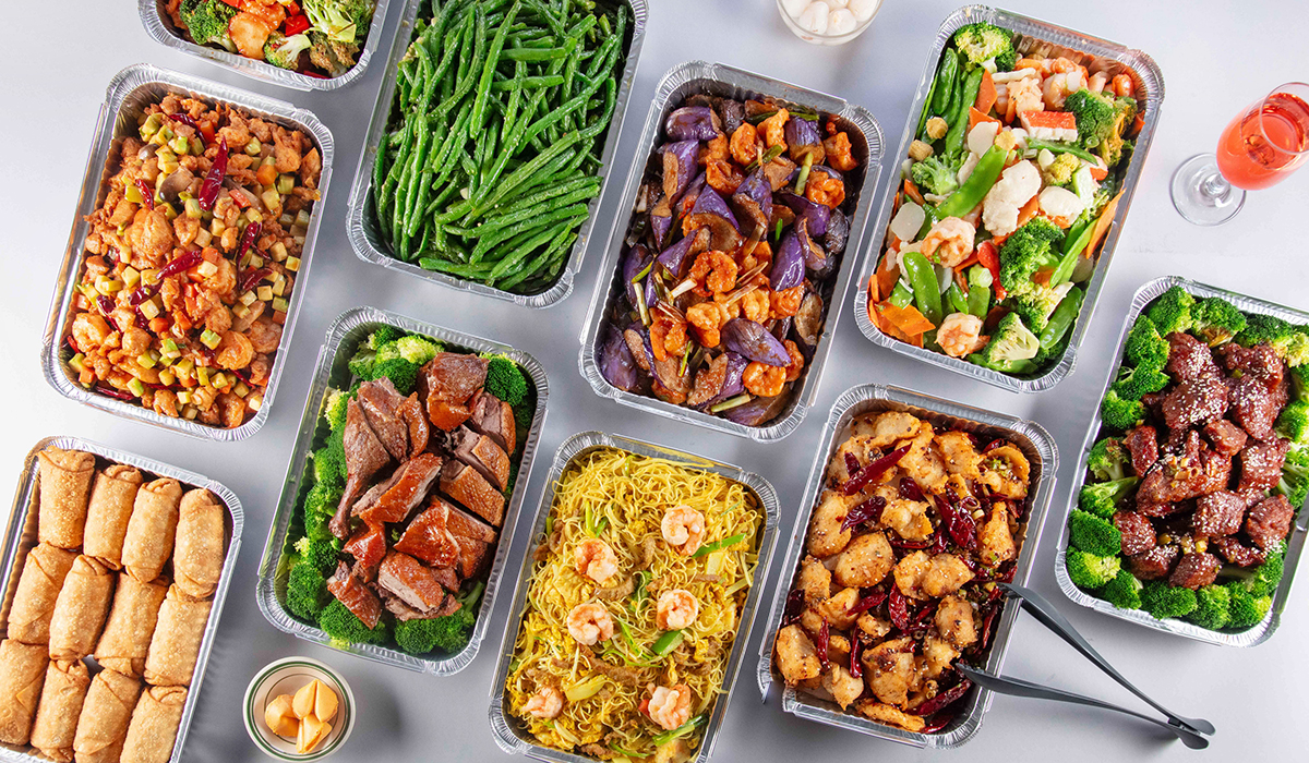 Catering trays of Chinese entrees noodles and egg rolls at Wok 88, a Chinese Restaurant in New York