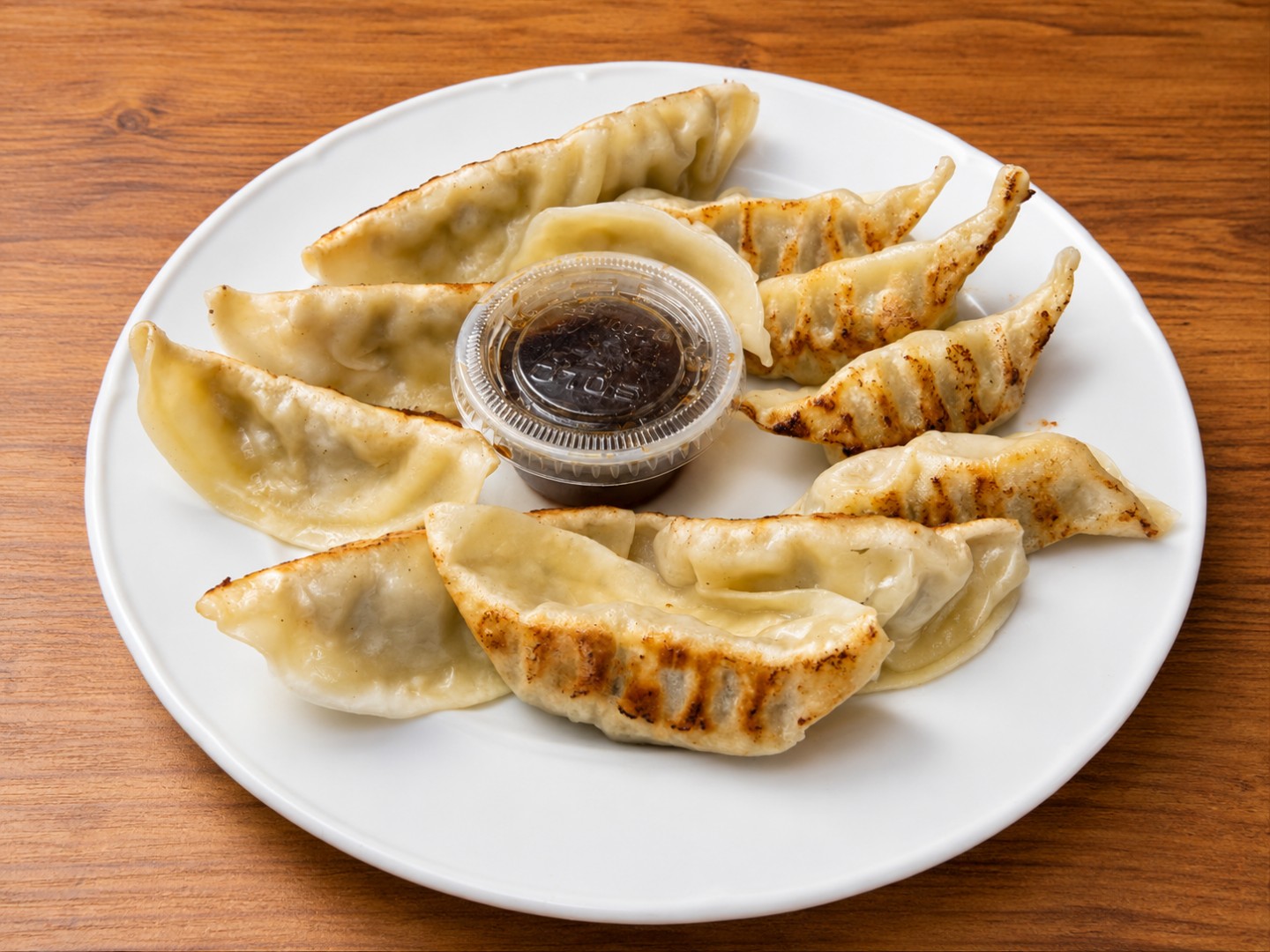 Pan fried dumplings with dipping sauce at Wok King Chinese Cuisine, a Chinese Restaurant in Indio