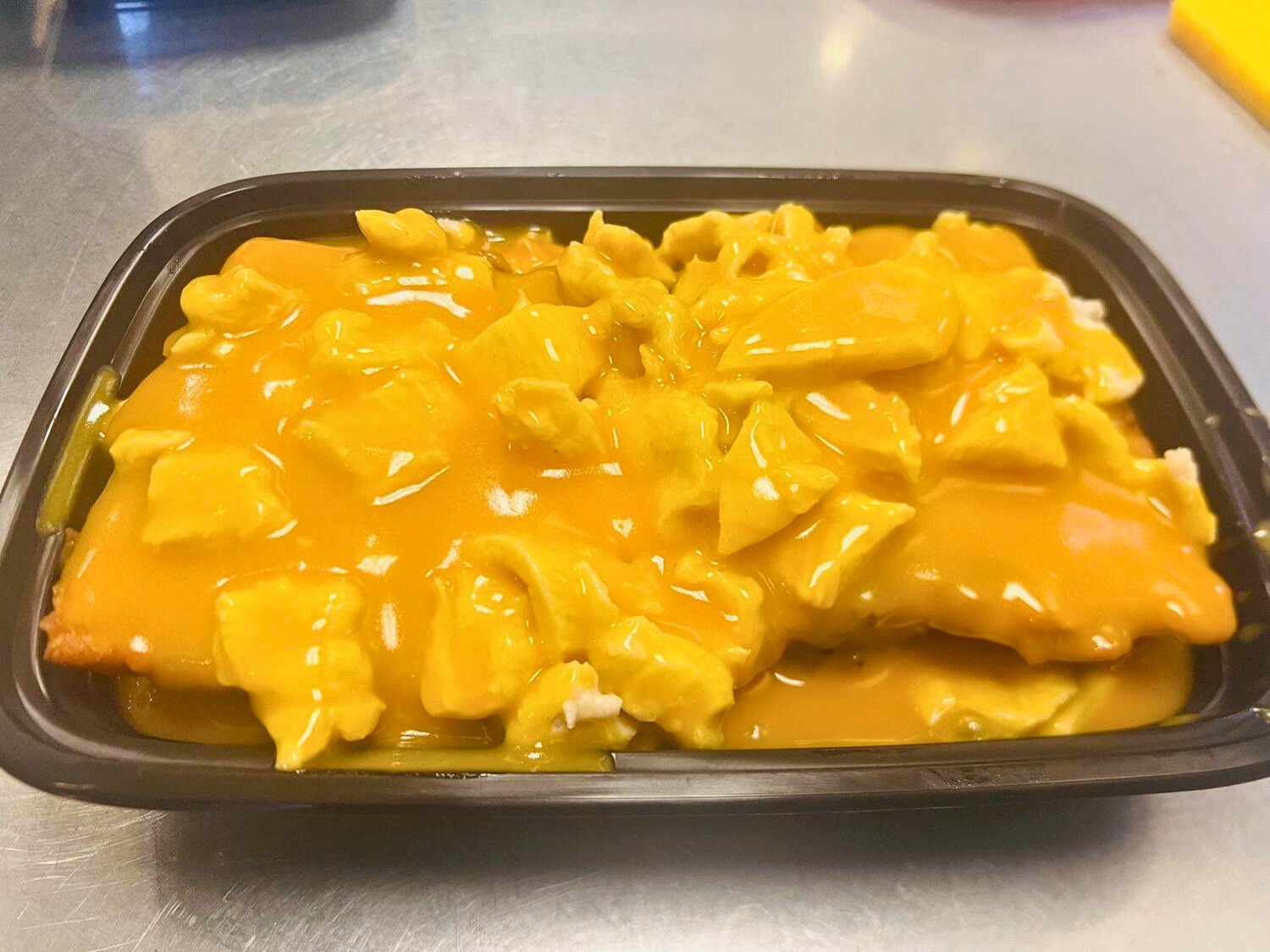 Description: Fluffy egg foo young with chicken and savory sauce at Wok's Cookin', a Chinese Restaurant in Castaic