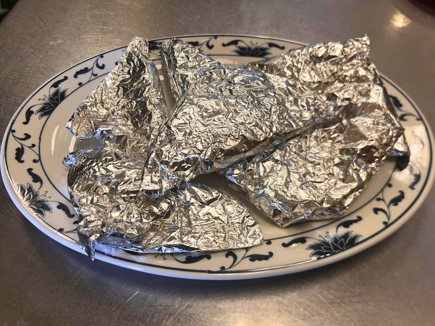 Tender chicken wrapped in paper for flavor at Wok's Cookin', a Chinese Restaurant in Castaic