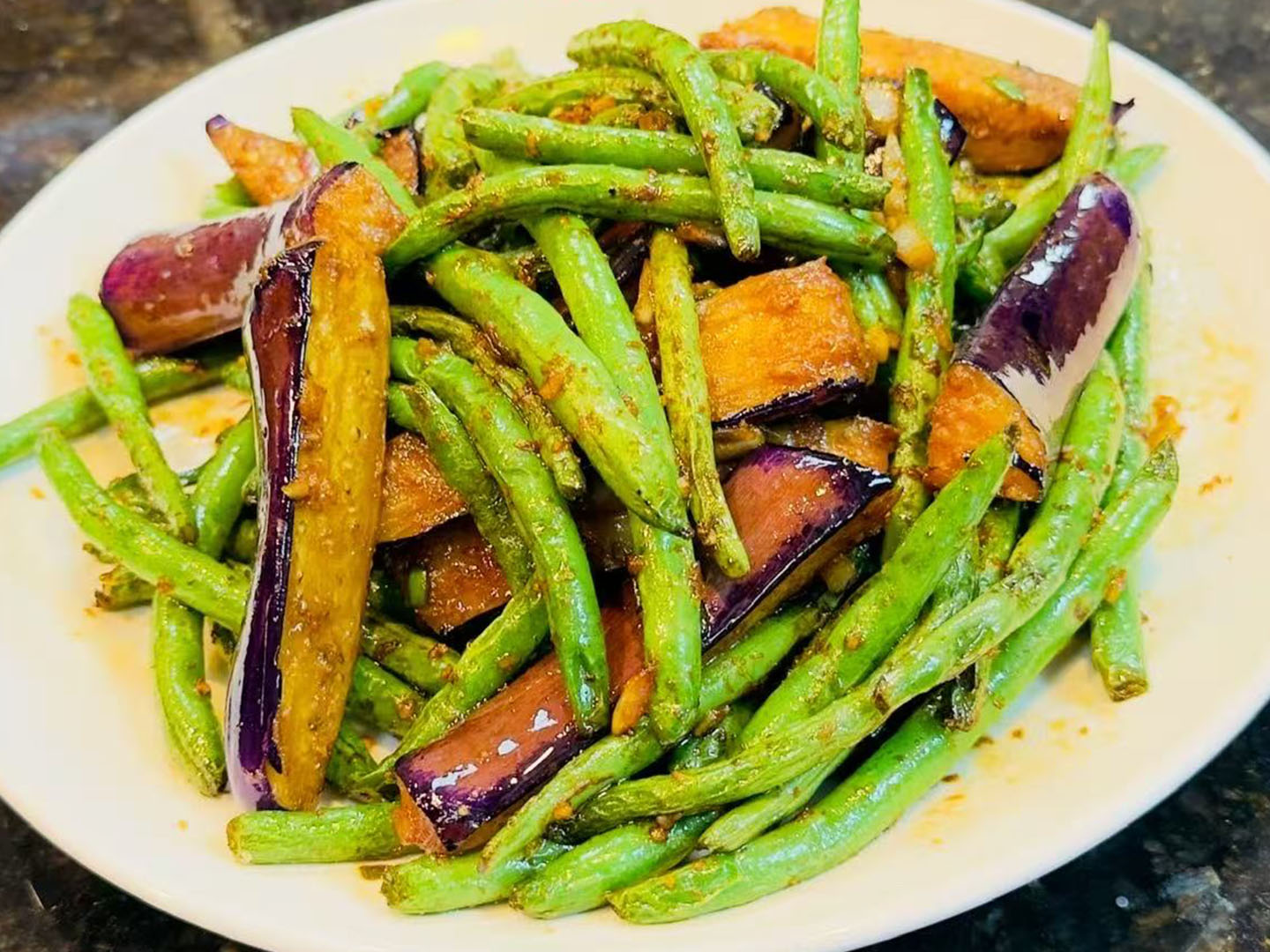 Stir-fried string beans and eggplant in savory sauce at Xiao Ling's Noodles & Dumplings, a Chinese Restaurant in The Colony