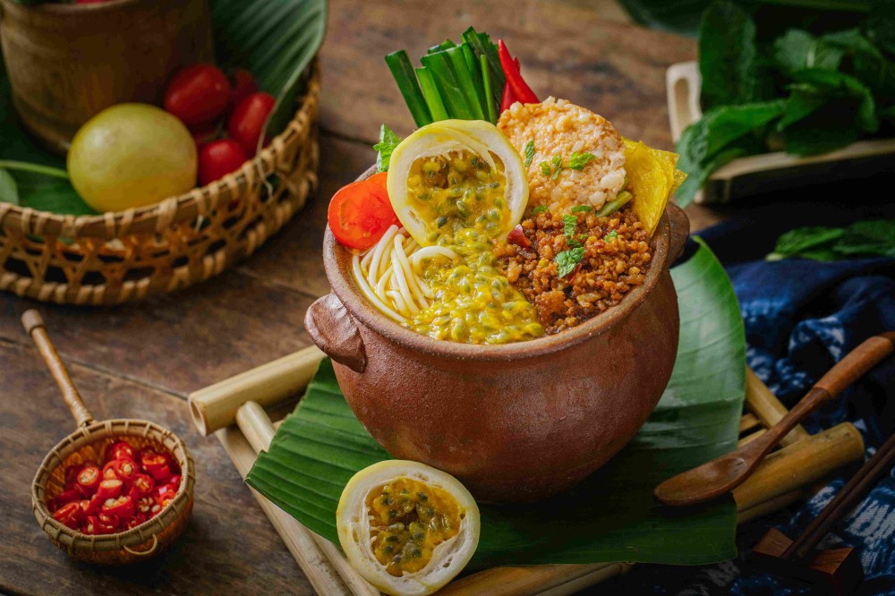 Passion fruit sour soup pot rice noodles with fresh herbs at Xiaozhan Rice Noodle, a Chinese Noodle Restaurant in Flushing