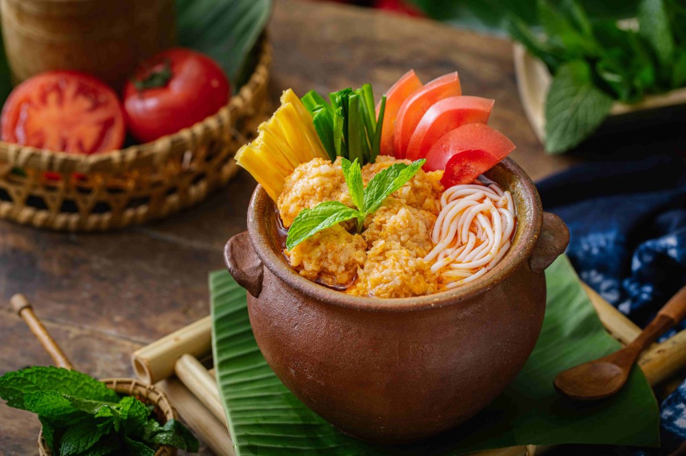 Tomato meatball pot rice noodles with mint and veggies at Xiaozhan Rice Noodle, a Chinese Noodle Restaurant in Flushing