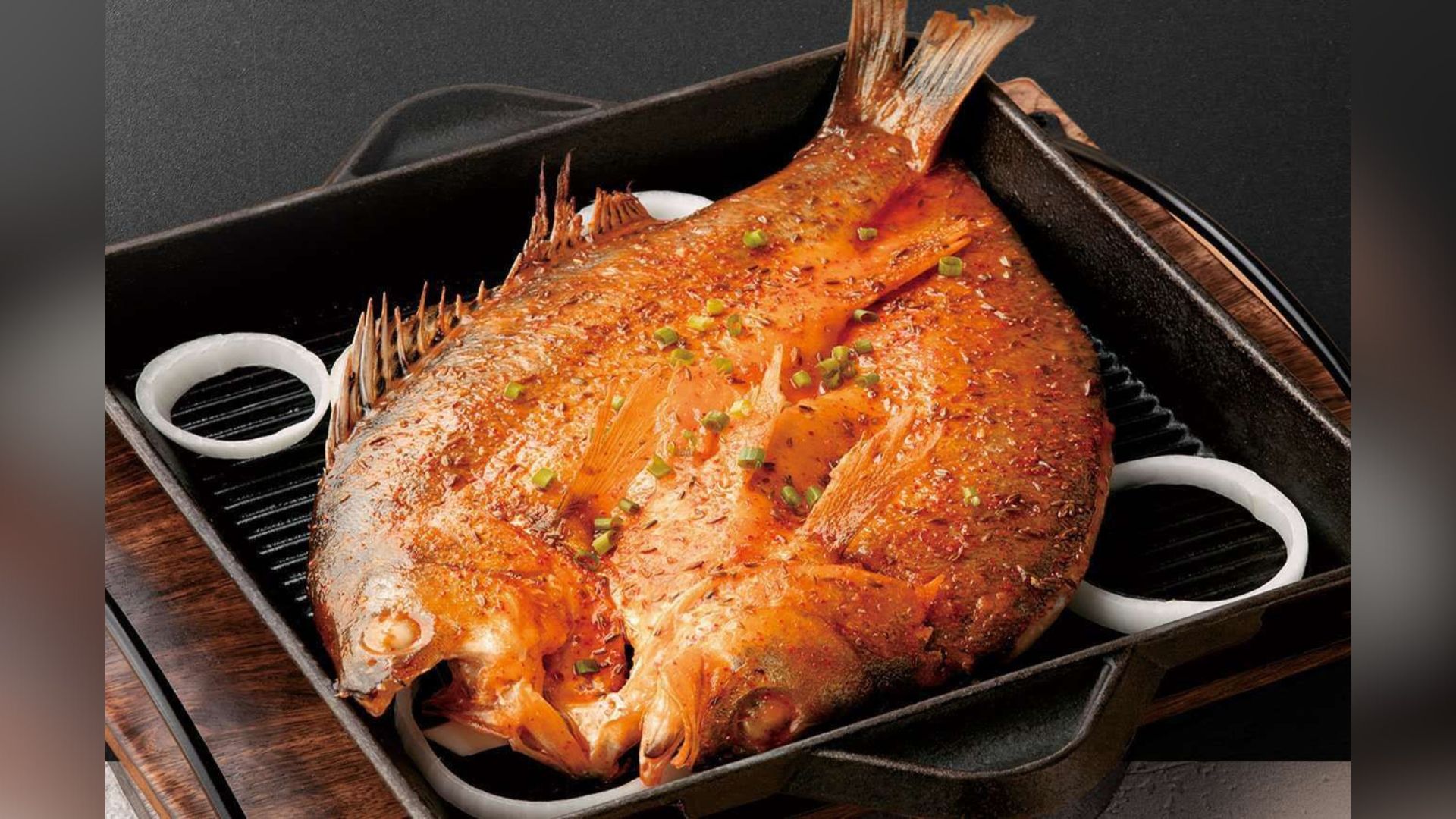 Grilled fish garnished with scallions at XIBEI, a Chinese Restaurant in Arcadia