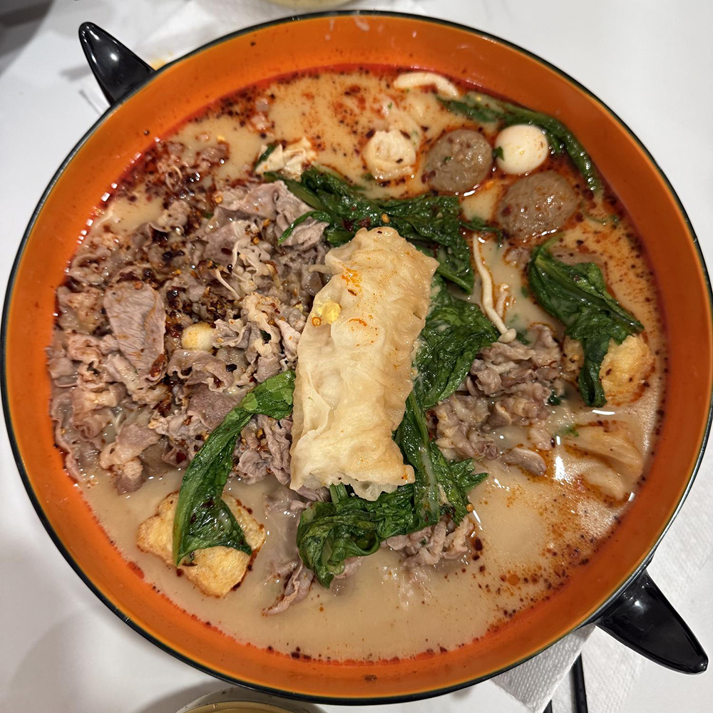 Rich spicy malatang soup with beef and tofu skin at Xin La Gong Fu, a Malatang Restaurant in Highland Park