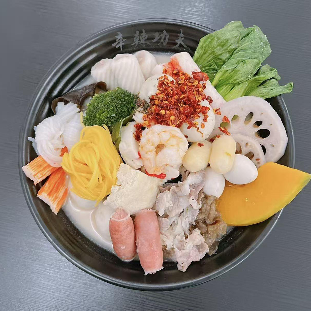 Creamy broth malatang with shrimp, vegetables and chili flakes at Xin La Gong Fu, a Malatang Restaurant in Highland Park