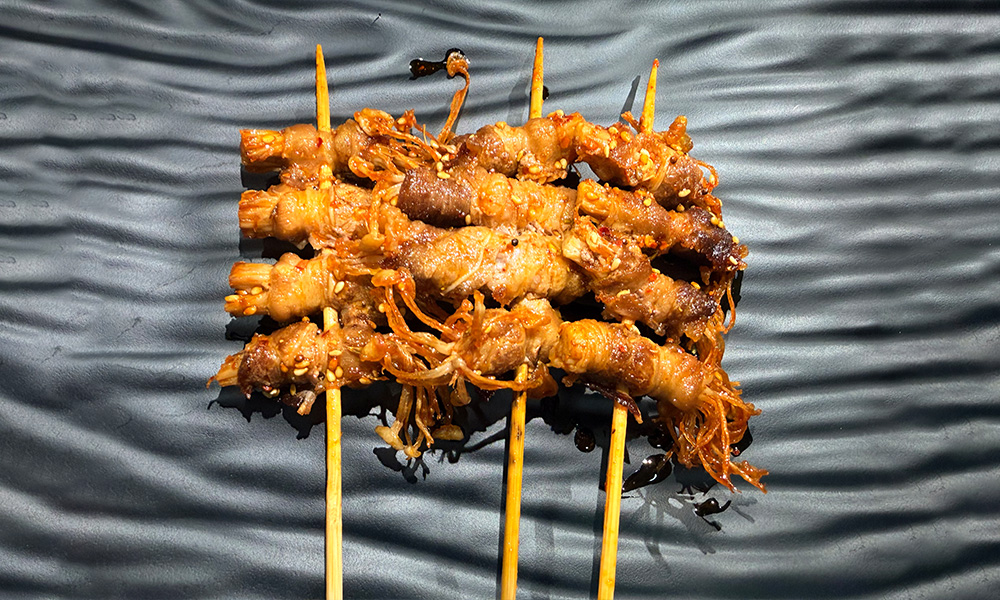 Grilled pork rolls wrapped with enoki mushrooms at Yami Bowl, a Asian Fusion Restauran in San Jose