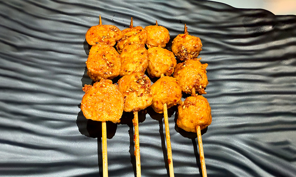 Spicy grilled meatball skewers with sesame at Yami Bowl, a Asian Fusion Restauran in San Jose
