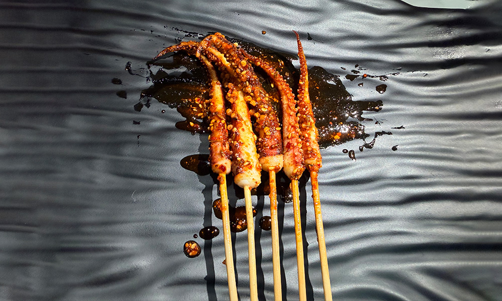 Spicy grilled squid tentacles with chili oil at Yami Bowl, a Asian Fusion Restauran in San Jose