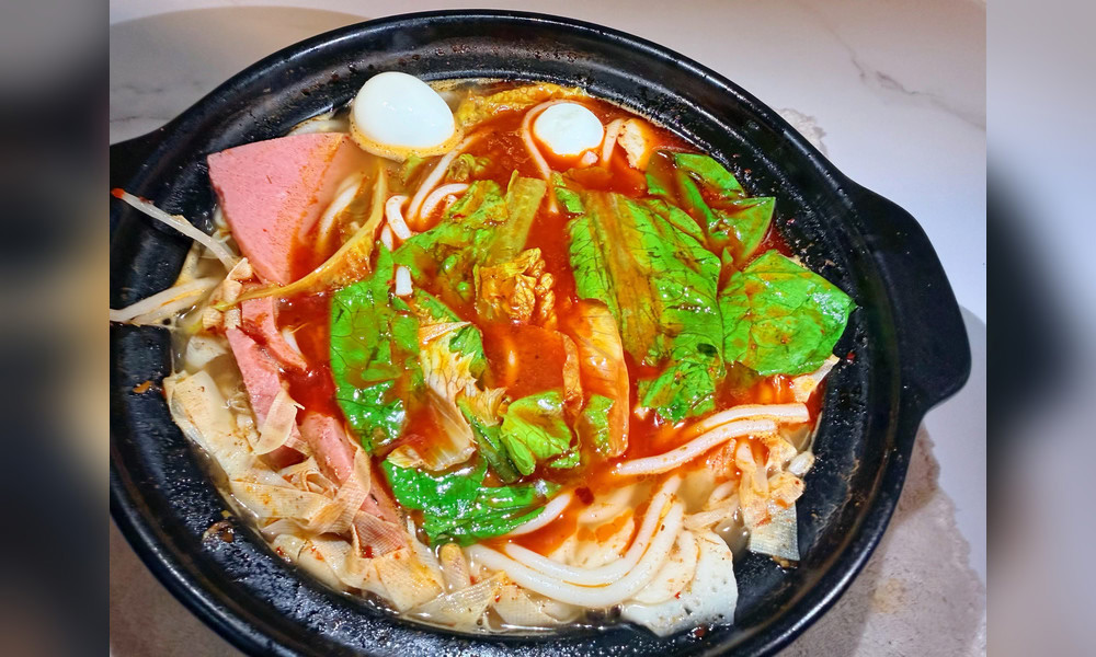Spicy red broth potato noodles in clay pot at Yami Bowl, a Asian Fusion Restauran in San Jose