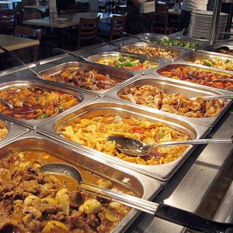 Metal trays filled with diverse hot savory dishes at Yami Buffet, a Buffet Restaurant in Glassboro