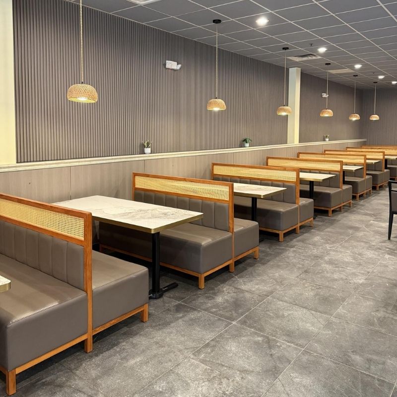 Modern rattan booth dining area with pendant lights at Yami Buffet, a Buffet Restaurant in Glassboro