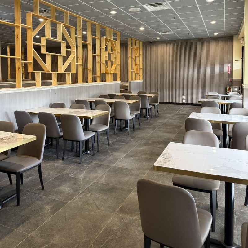 Simple round tables and grey chairs dining space at Yami Buffet, a Buffet Restaurant in Glassboro