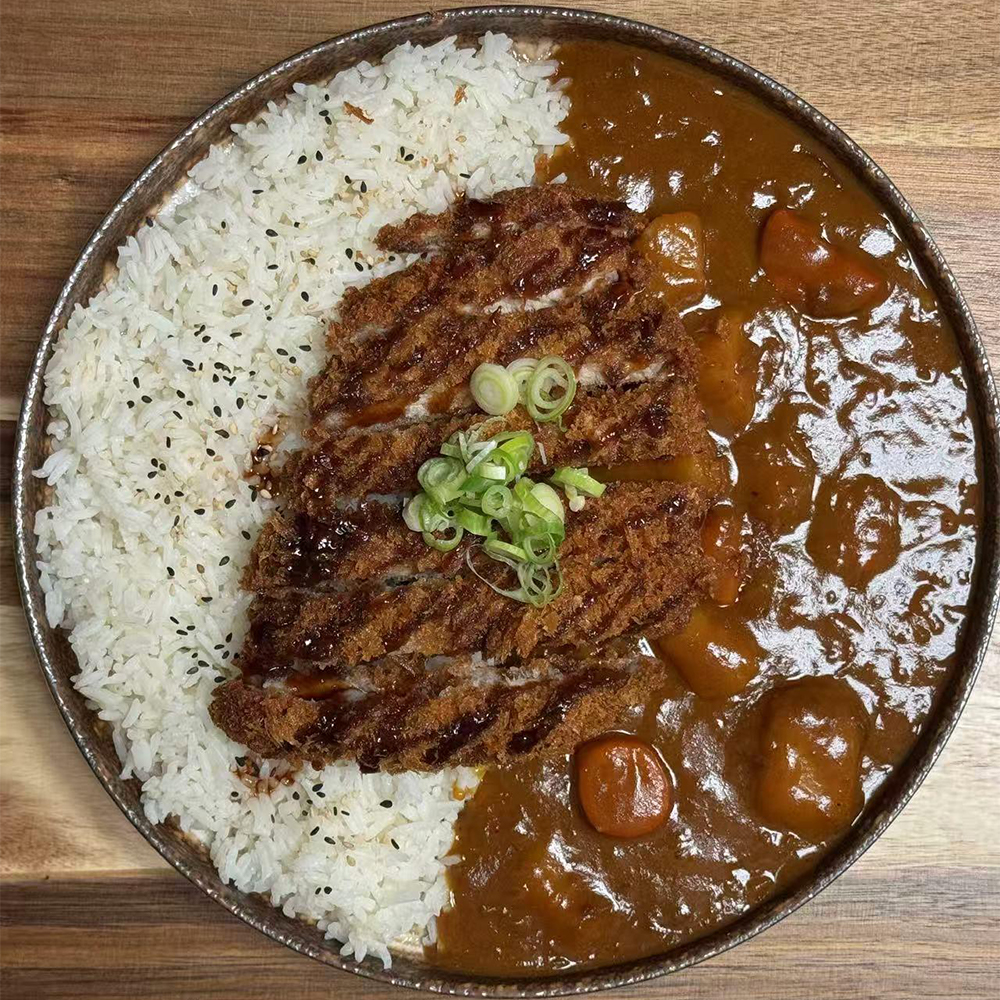 Advertisement for Yasakani Ramen & Grill's Tonkotsu Ramen, priced at $16.5. Highlights creamy pork broth, soft-boiled egg, chashu, and fresh toppings. Includes contact information: call 309-349-3162 or visit 3560 Court Street.