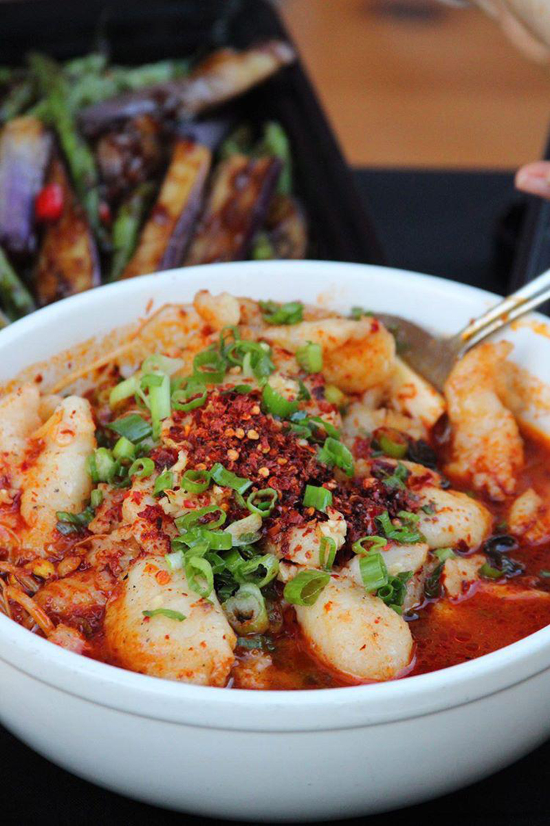Tender boiled fish in spicy red broth with chili flakes at Ya Ya, a Chinese Restaurant in Houston