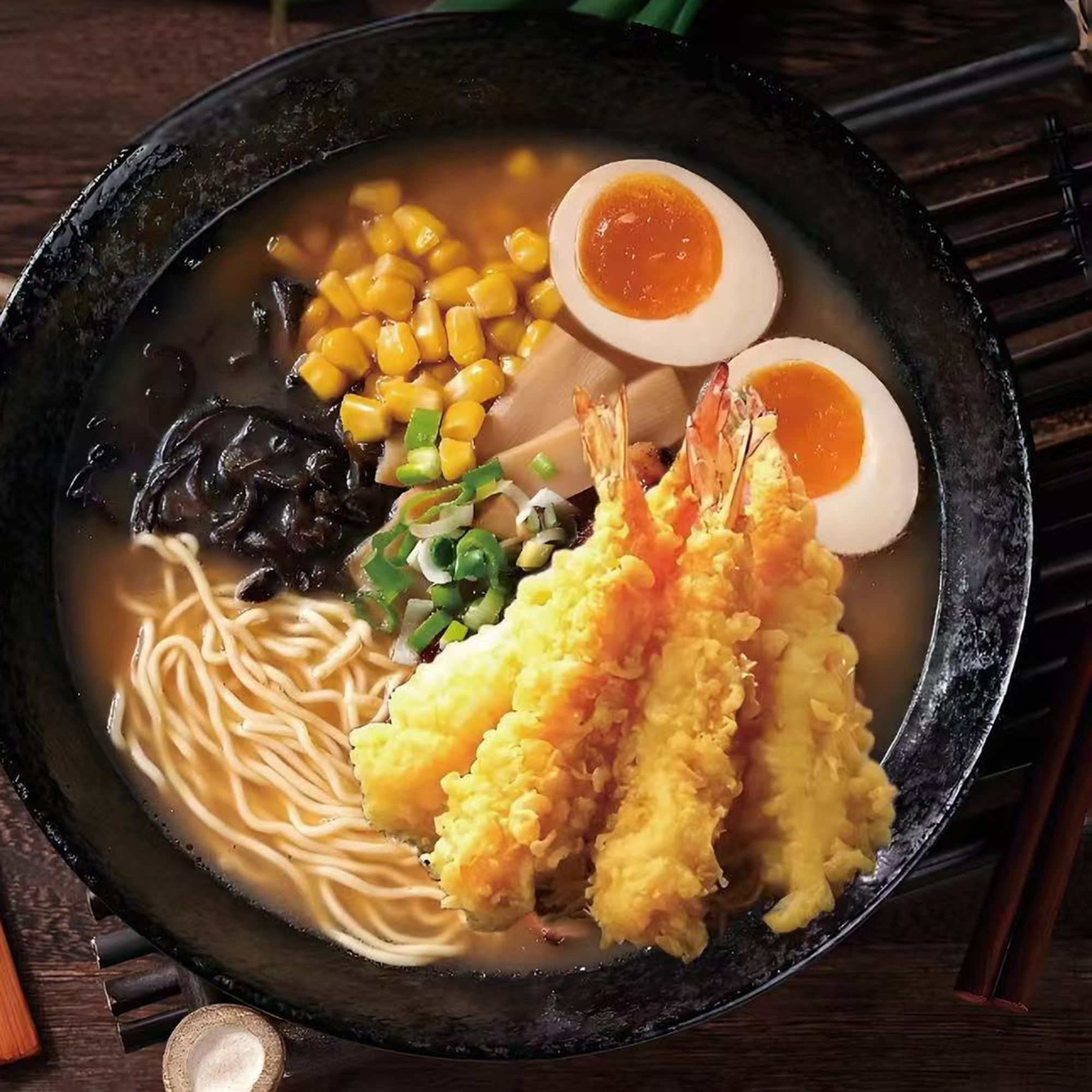 A bowl of shrimp tempura ramen with noodles, corn, soft - boiled eggs, mushrooms, scallions, and crispy shrimp tempura in a savory broth at Yaya's Bowl Ramen & Dumpling，a Chinese Restaurant in Wilmington