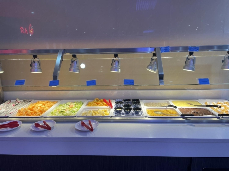 Dessert and fruit bar with cakes, fruits, and puddings at YC Seafood Hot Pot, a Hot Pot Restaurant in Virginia Beach